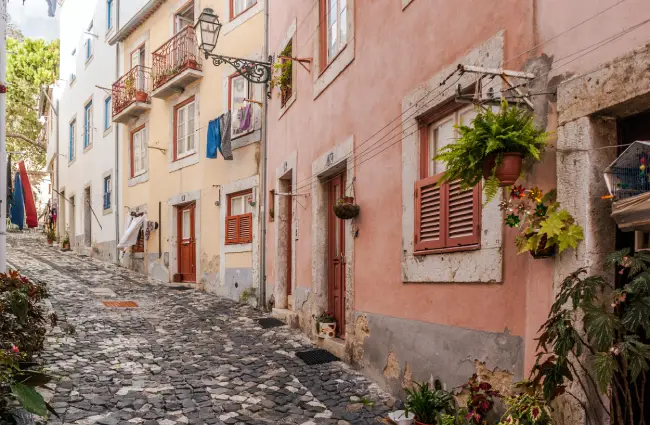 Colorful street scene in Lisbon's Alfama neighborhood