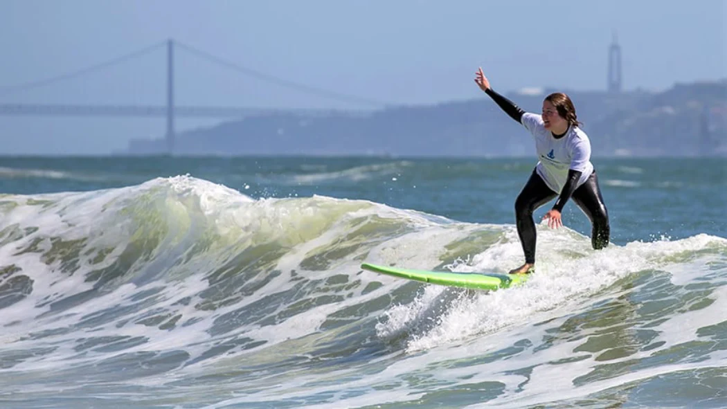 An intermediate taking surf lessons in the Lisbon surf school