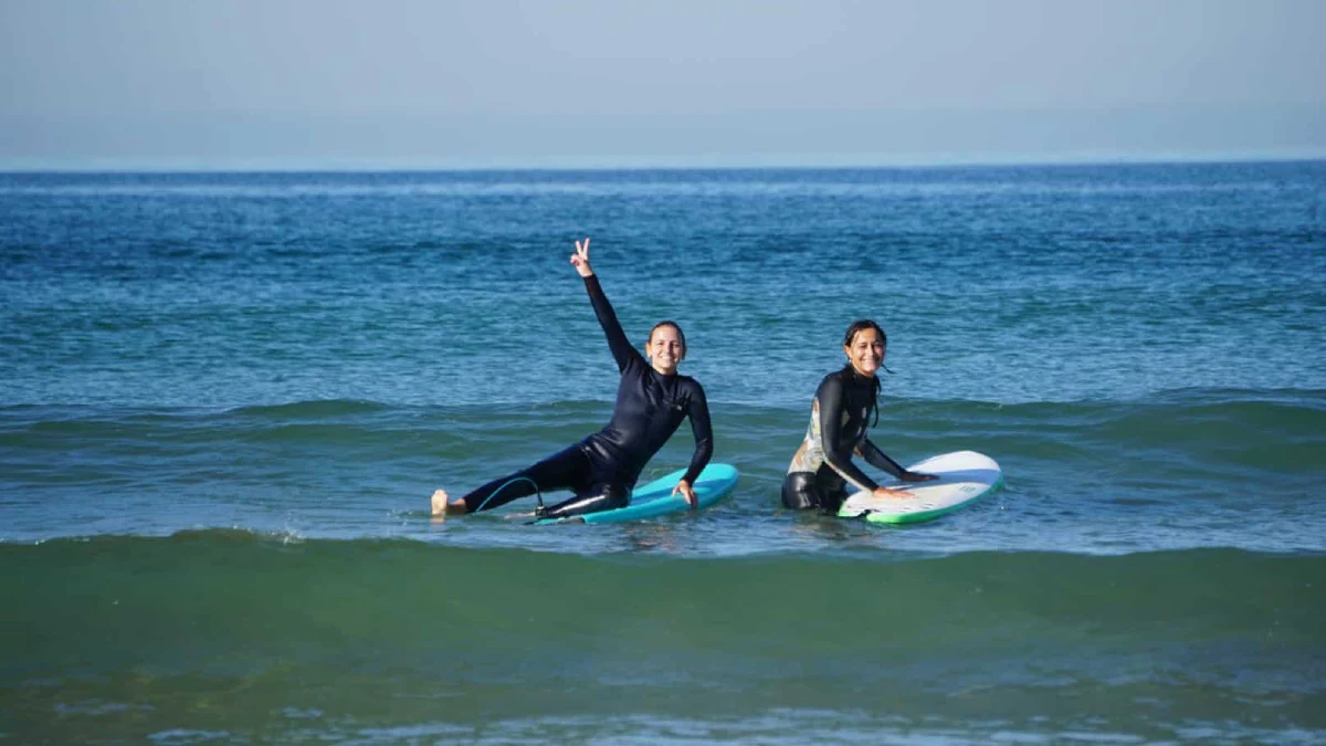 Two people surfing in Lisbon
